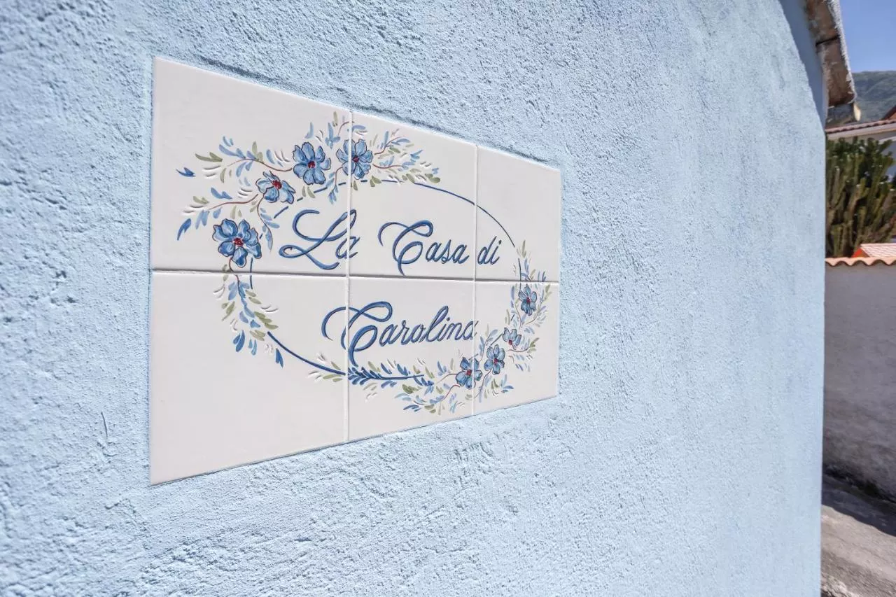 L'insegna in ceramica dipinta della Casa di Carolina
